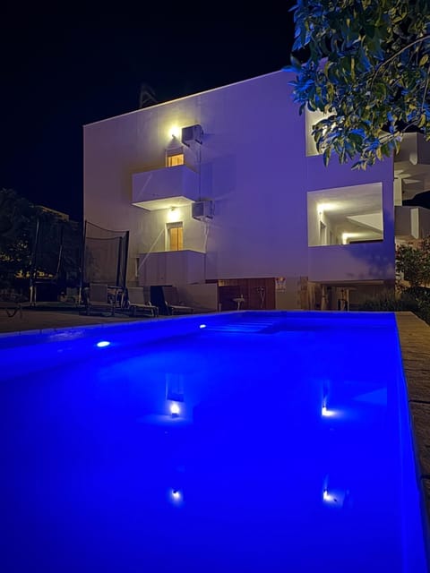 Property building, Patio, Night, Pool view, Swimming pool, Swimming pool, sunbed