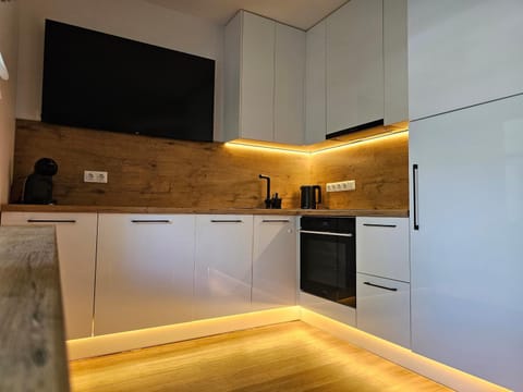 Kitchen or kitchenette, dishwasher, oven, stove