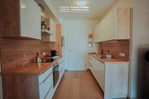 Kitchen or kitchenette, dishwasher, microwave, oven, stove