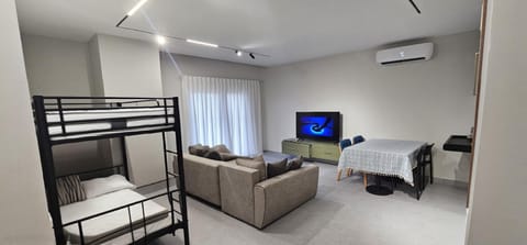 Communal lounge/ TV room, TV and multimedia, Living room, Seating area, bunk bed, air conditioner