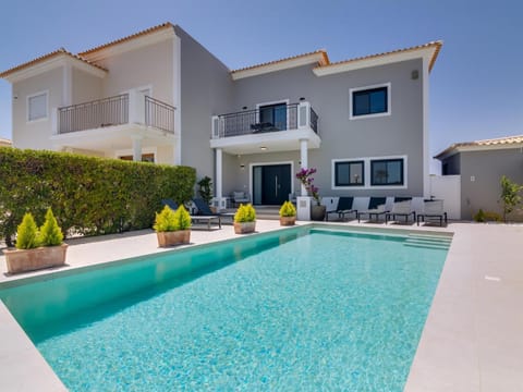 Property building, Patio, Pool view, Swimming pool, sunbed