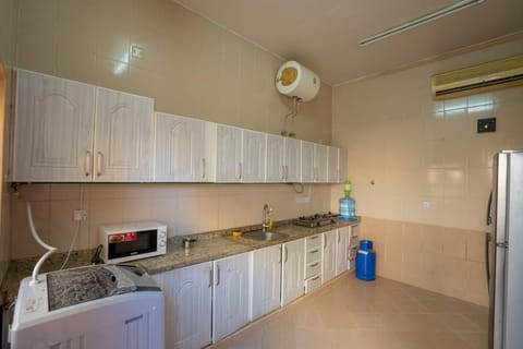 Kitchen or kitchenette, oven, stove, washing machine, dryer, air conditioner