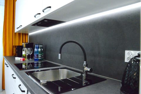 Kitchen or kitchenette, dishwasher, microwave, oven, stove