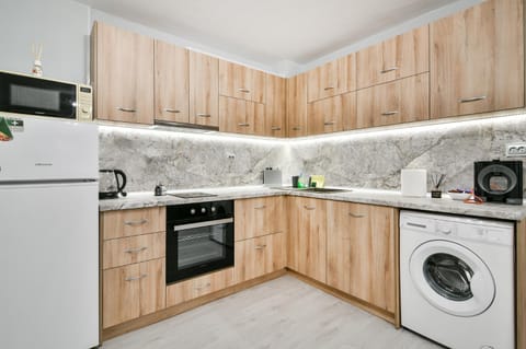 Kitchen or kitchenette, dishwasher, oven, stove, washing machine