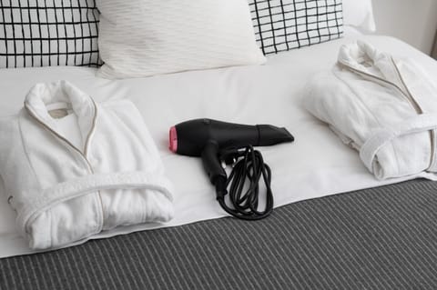 Bed, hair dryier, towels