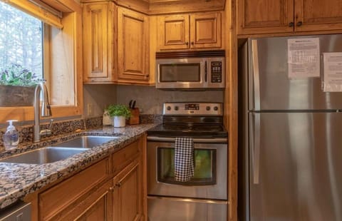 Kitchen or kitchenette, dishwasher, oven, stove