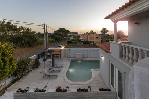 Property building, Patio, Balcony/Terrace, Pool view, Swimming pool, Sunset, sunbed