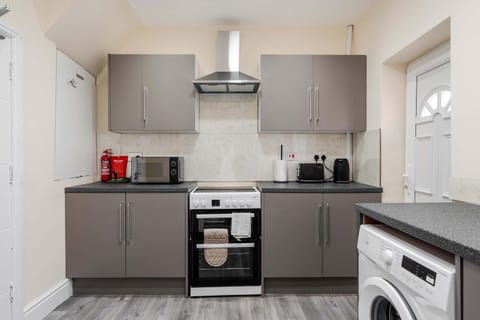 Kitchen or kitchenette, oven, stove, toaster, washing machine