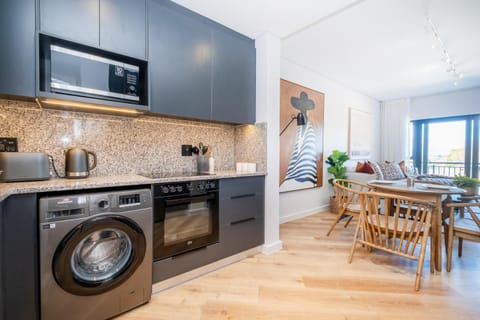 Kitchen or kitchenette, Dining area, microwave, oven, stove, toaster, washing machine