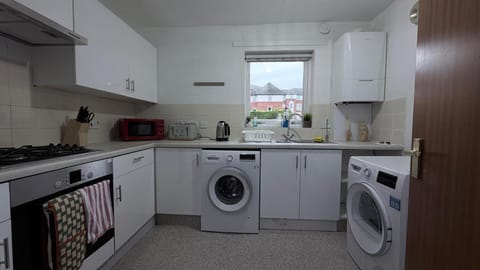 Kitchen or kitchenette, dishwasher, oven, stove, toaster, washing machine, dryer