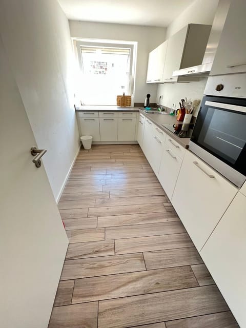 Kitchen or kitchenette, dishwasher, oven, stove