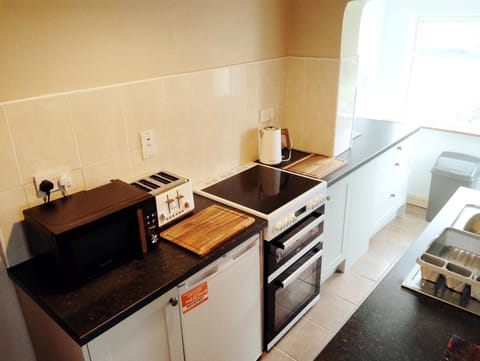 Kitchen or kitchenette, dishwasher, microwave, oven, stove, toaster