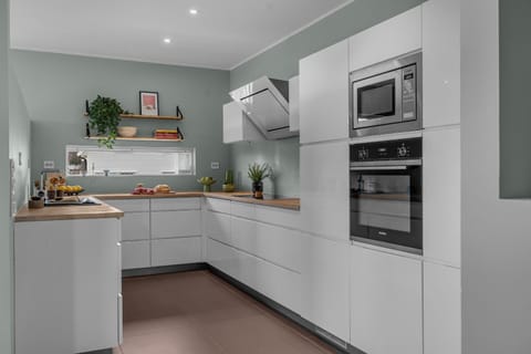 Kitchen or kitchenette, dishwasher, oven, stove