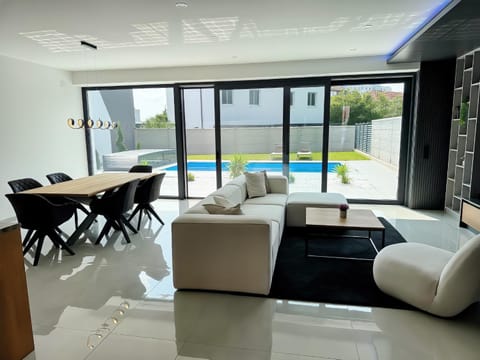 Living room, Seating area, Dining area, Pool view