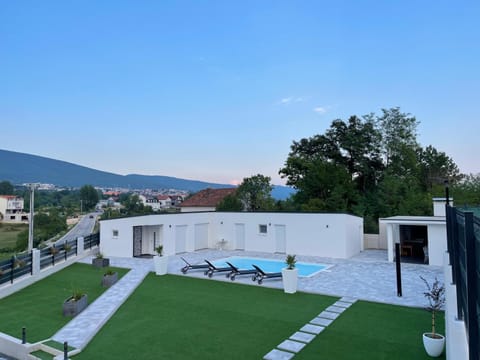 Property building, Patio, Natural landscape, Mountain view, Pool view, sunbed