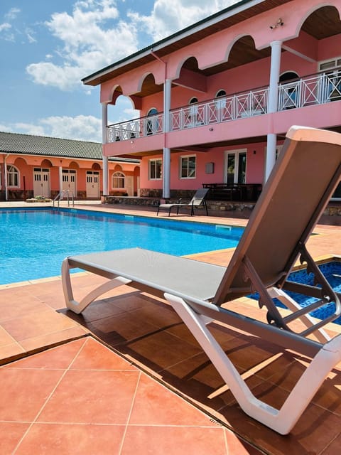 Property building, Patio, Pool view, Swimming pool, sunbed