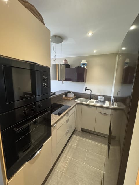 Kitchen or kitchenette, microwave, oven, stove