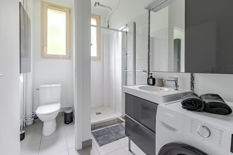 Shower, Toilet, Bathroom, hair dryier, towels, washing machine, dryer