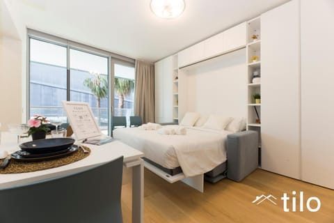 Bed, Photo of the whole room, Bedroom, Text overlay, towels