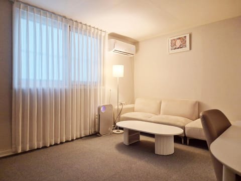 Property building, Living room, Seating area, Bedroom, air conditioner