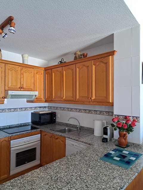 Kitchen or kitchenette, dishwasher, microwave, stove