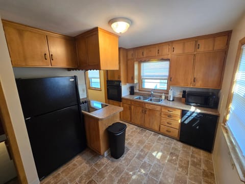 Kitchen or kitchenette, dishwasher, oven, stove