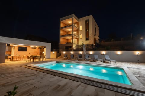 Property building, Patio, Night, Pool view, Swimming pool, sunbed