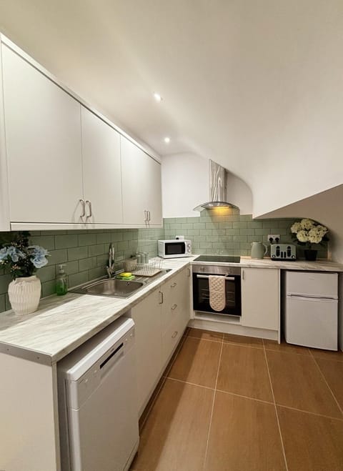 Kitchen or kitchenette, dishwasher, oven, stove, toaster