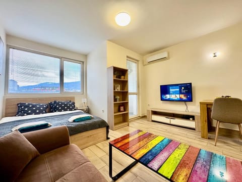 Bed, TV and multimedia, Living room, Seating area, air conditioner