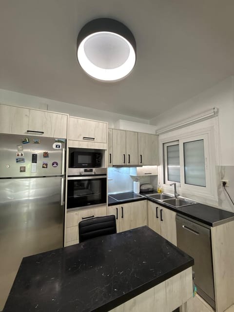 Kitchen or kitchenette, dishwasher, oven, stove