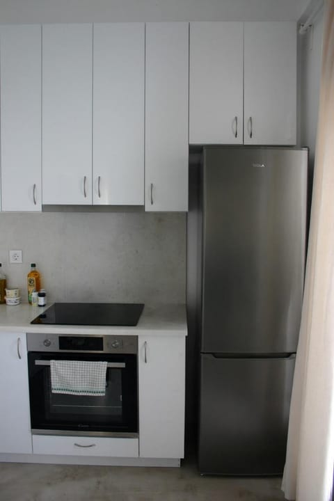 Kitchen or kitchenette, dishwasher, oven, stove