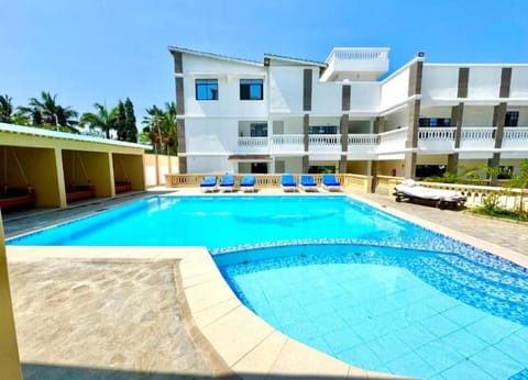 Property building, Patio, Pool view, Swimming pool, sunbed
