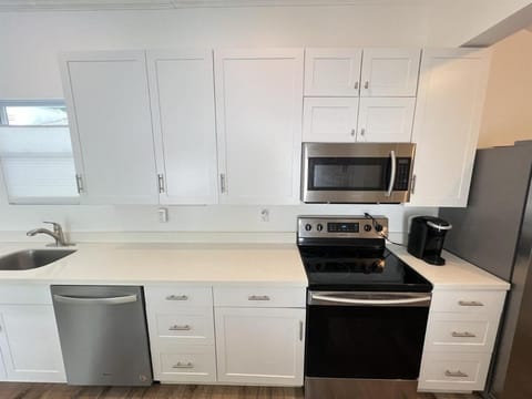 Kitchen or kitchenette, dishwasher, oven, stove