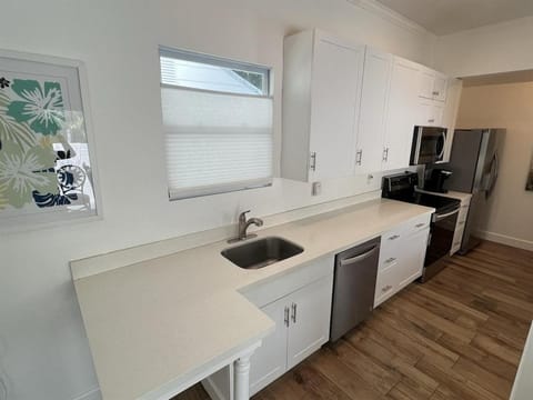 Kitchen or kitchenette, dishwasher, oven, stove