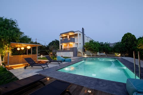 Property building, Patio, Night, Natural landscape, Pool view, Swimming pool, sunbed