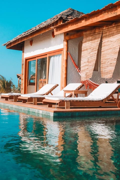 Property building, Patio, Pool view, Swimming pool, sunbed
