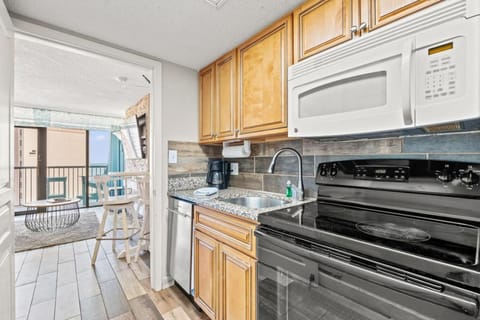 Kitchen or kitchenette, dishwasher, microwave, oven, stove
