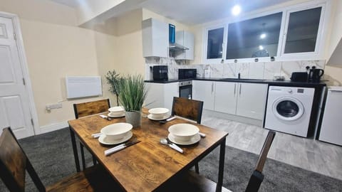 Kitchen or kitchenette, Seating area, Dining area, oven, stove, toaster, washing machine