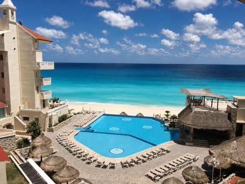 Property building, Patio, Nearby landmark, Day, Beach, Pool view, Sea view, Swimming pool, sunbed