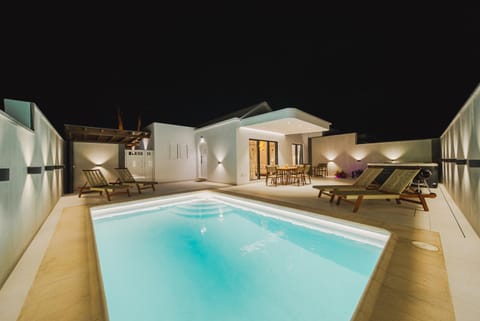 Property building, Patio, Night, Pool view, Swimming pool, sunbed