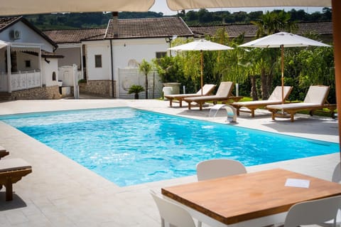 Property building, Natural landscape, Pool view, Swimming pool, sunbed