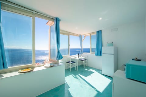 Natural landscape, Kitchen or kitchenette, Living room, Seating area, Dining area, Sea view