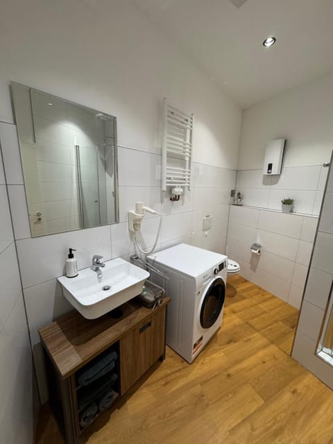 Toilet, Bathroom, hair dryier, towels, washing machine