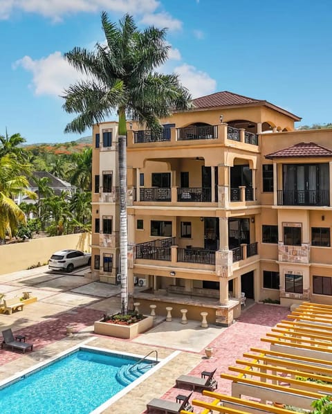 Property building, Patio, Pool view, Swimming pool, sunbed