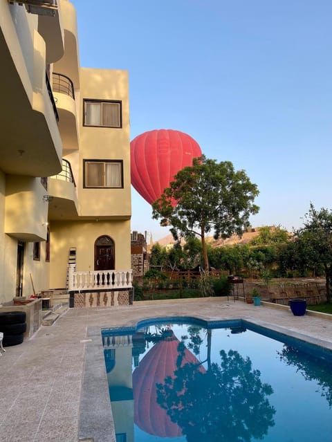 Property building, Patio, Pool view, Swimming pool, sunbed