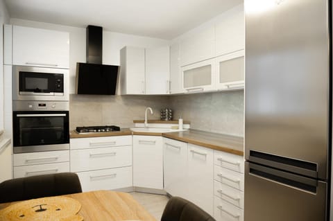 Kitchen or kitchenette, dishwasher, oven, stove