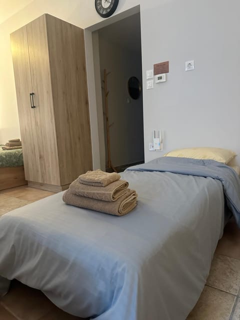 Bed, towels, wardrobe