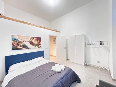 Bed, towels, wardrobe