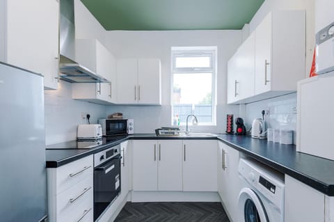 Kitchen or kitchenette, oven, stove, toaster, washing machine