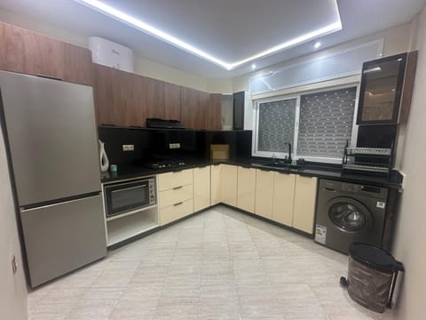 Kitchen or kitchenette, oven, stove, washing machine